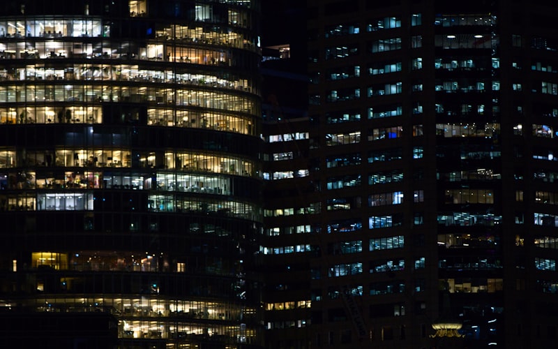 Modern commercial office buildings illuminated at night — backup power keeps business running