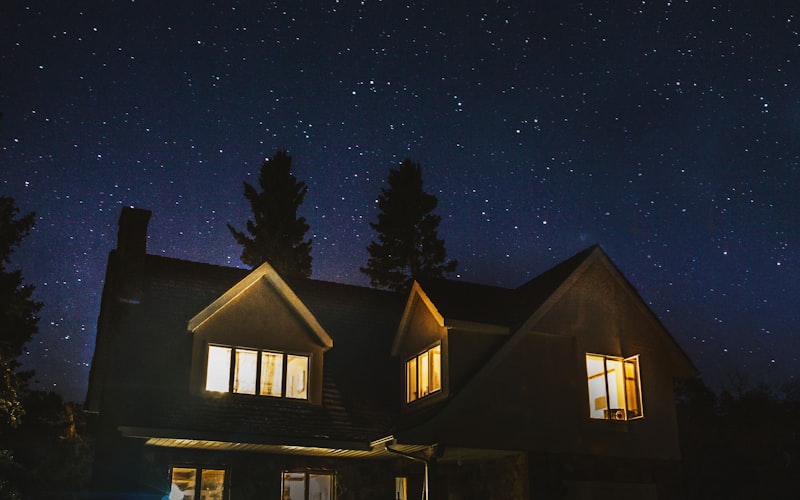 Residential home with warm lights under a starry night sky — standby power protects your family