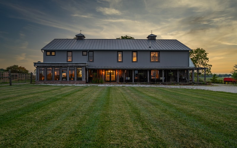 Rural barn-style home at twilight with warm interior lights — dependable off-grid backup power
